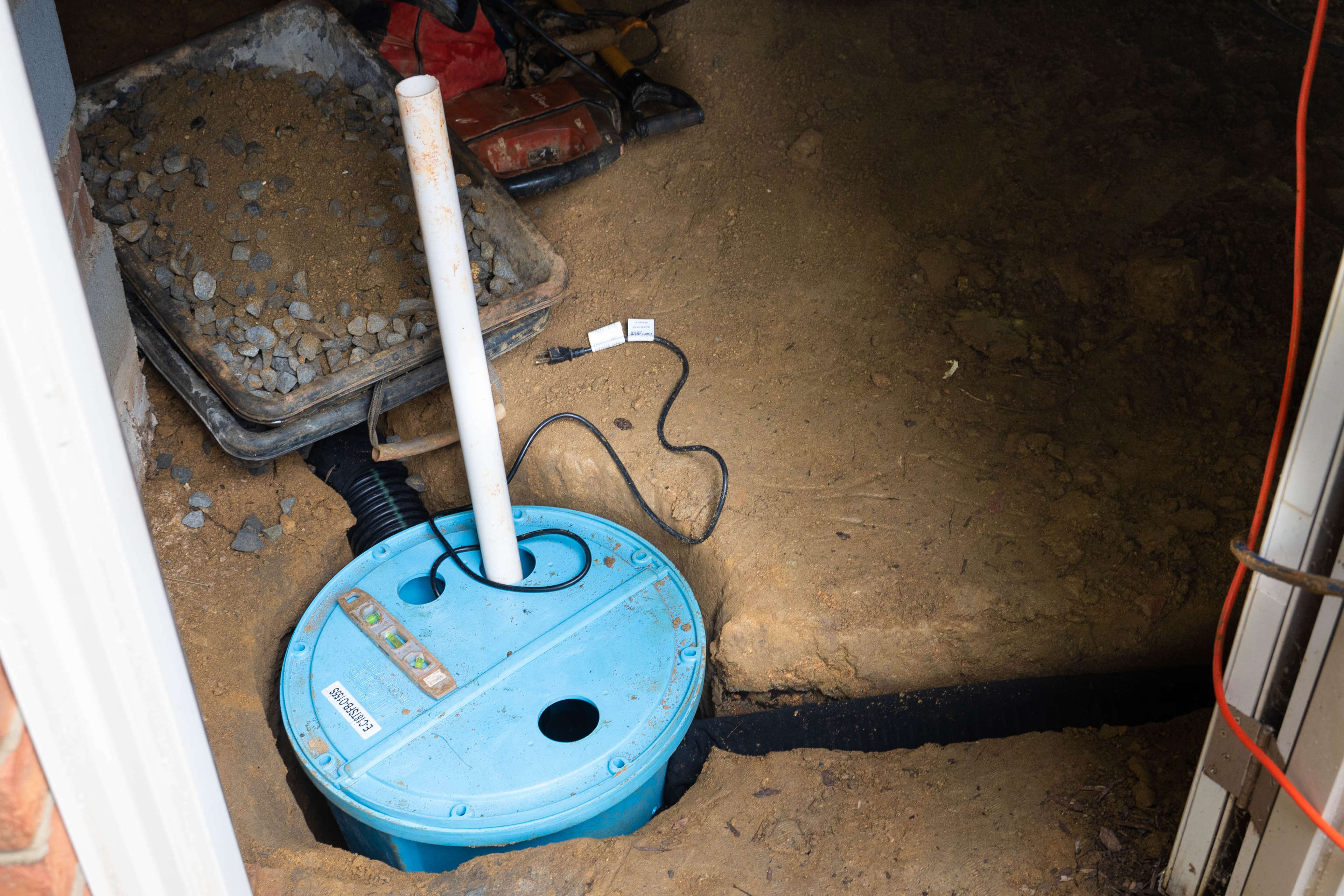 drainage and a sump pump installed in a crawl space floor