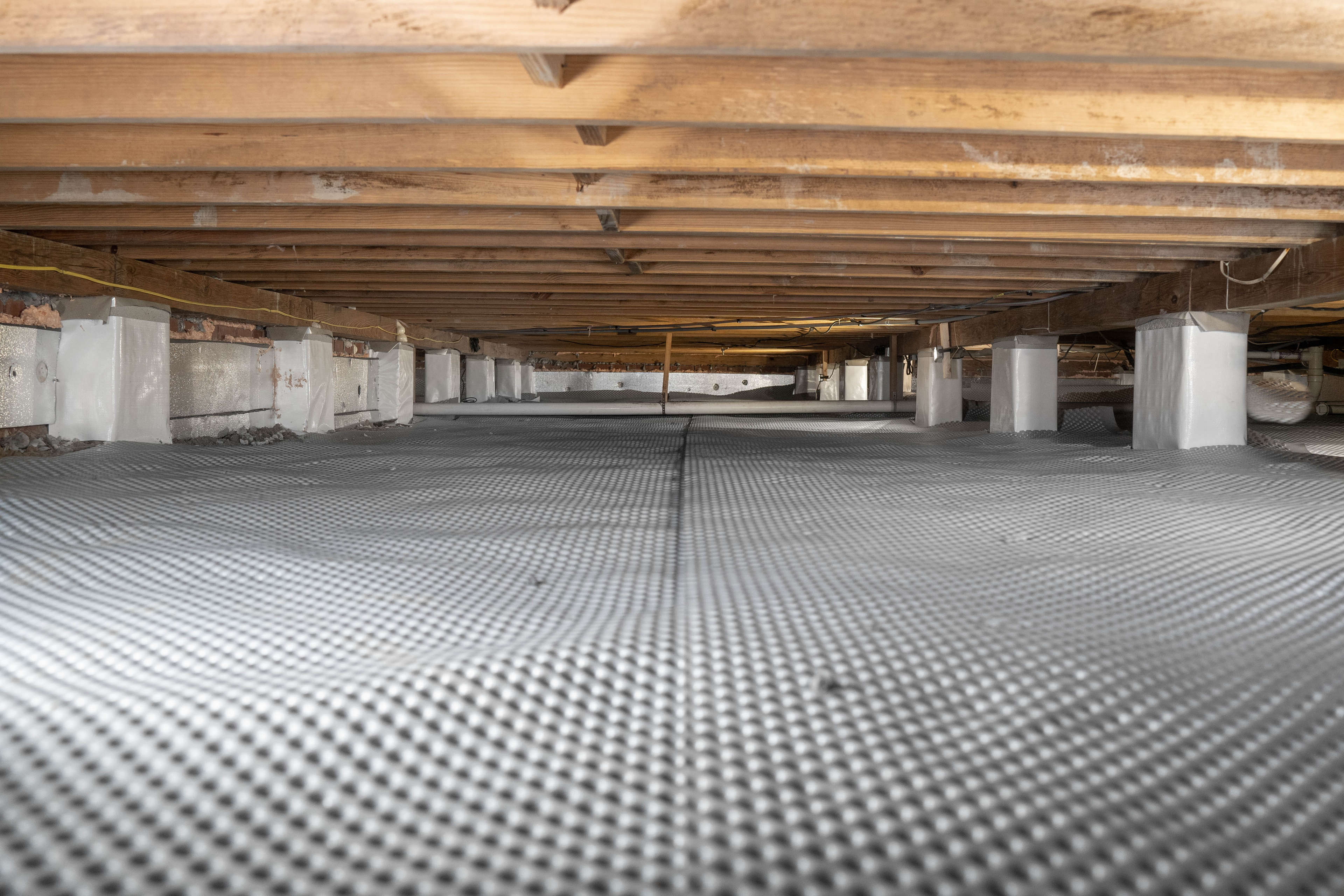 drainage matting placed on a crawl space floor before encapsulation