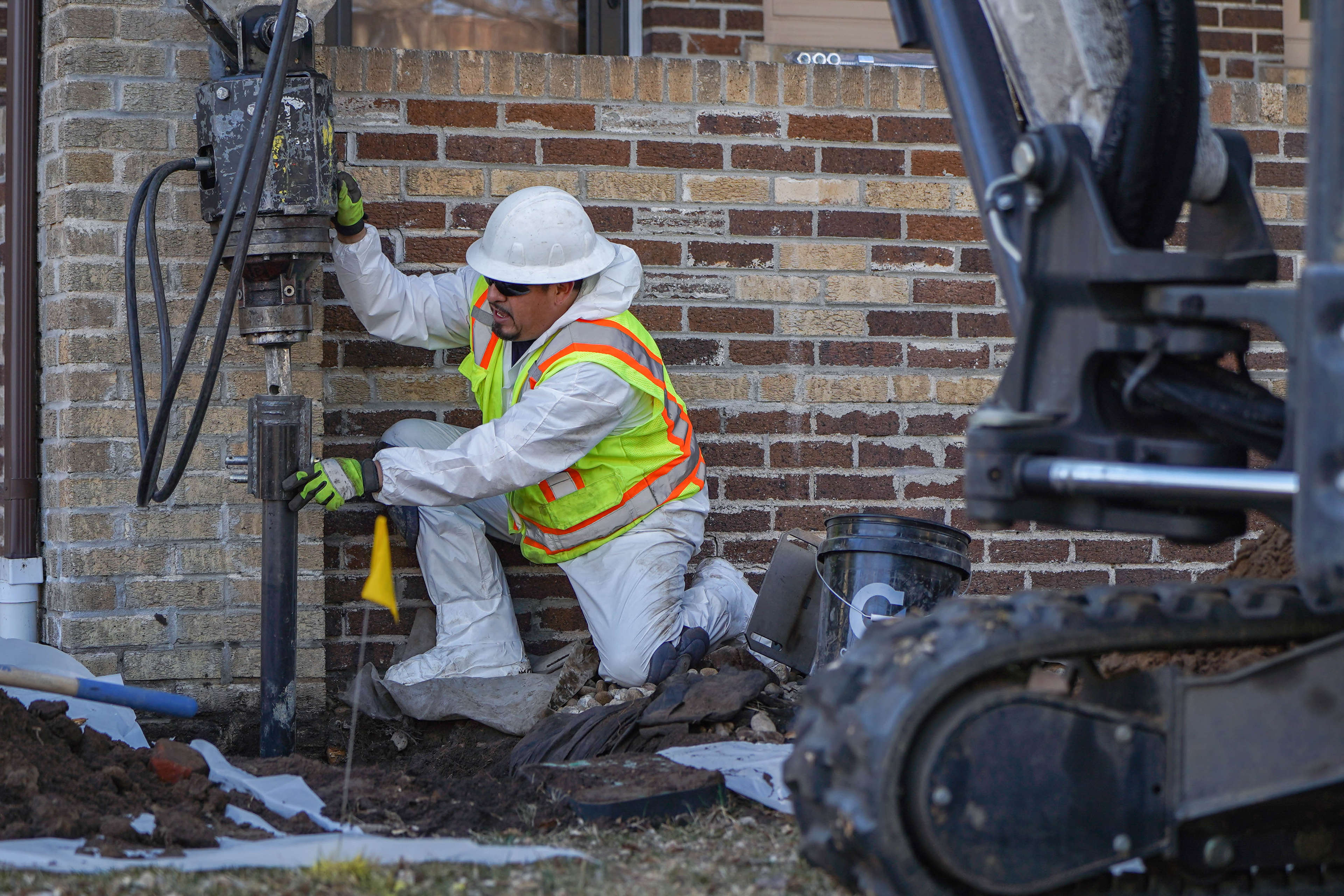 crew member installing a helical pier