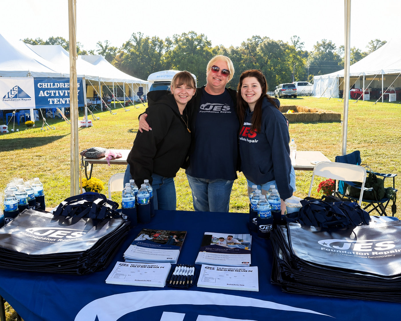 JES employees stand at a company booth at the Youth For Tomorrow's Country Fair & Auction