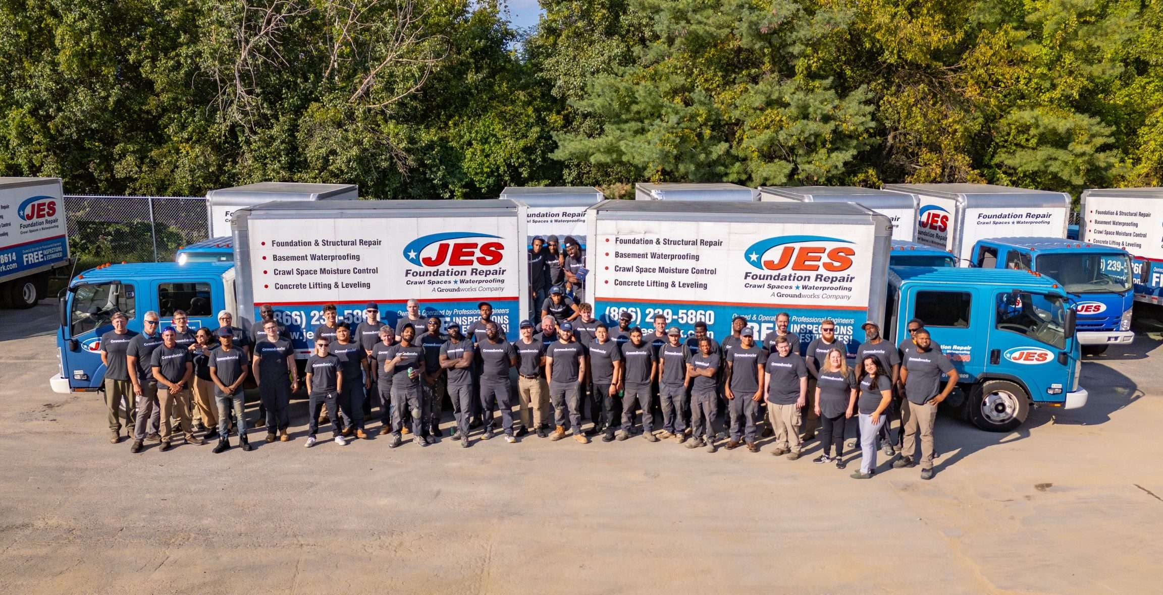 JES Foundation Repair employees standing by company trucks