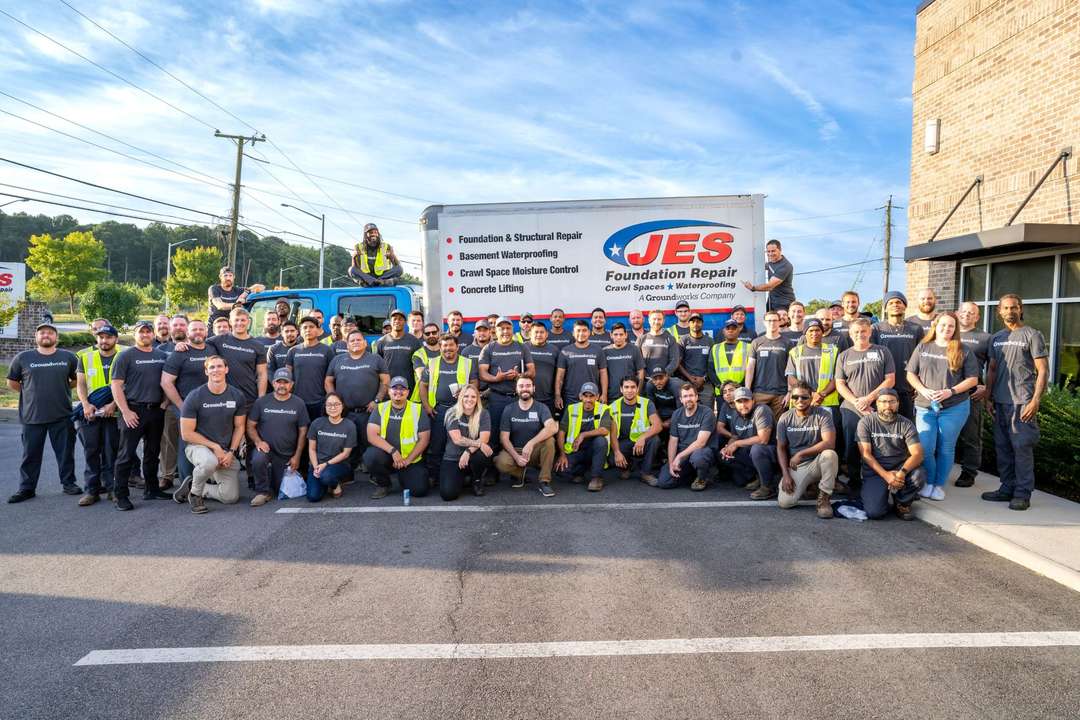 JES employees standing by a company truck