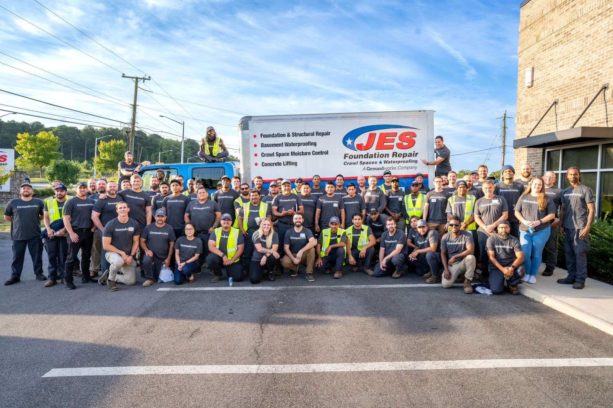 JES employees standing by company trucks