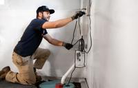 JES crew member installs a basement sump pump