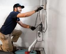 JES crew member installs a basement sump pump