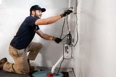 JES crew member installs a basement sump pump