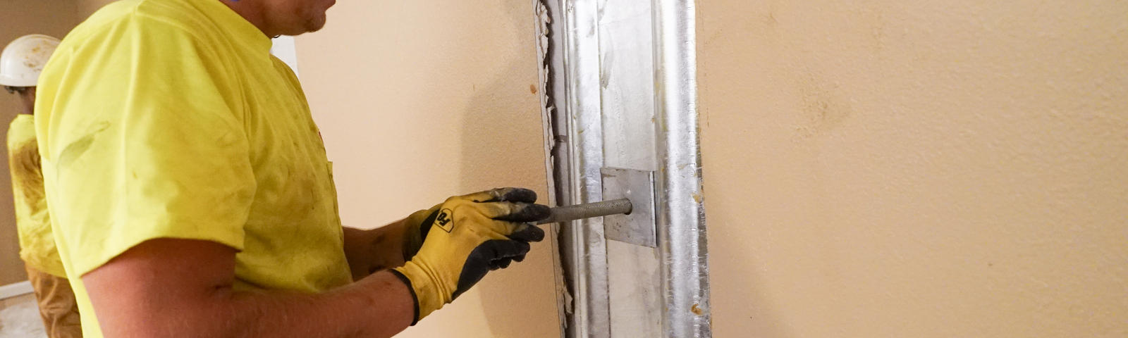 crew member installs an interior wall anchor plate