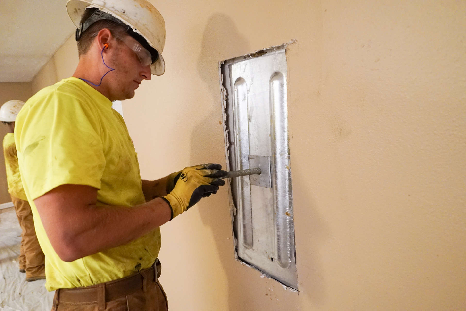 crew member installs an interior wall anchor plate
