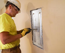 crew member installs an interior wall anchor plate