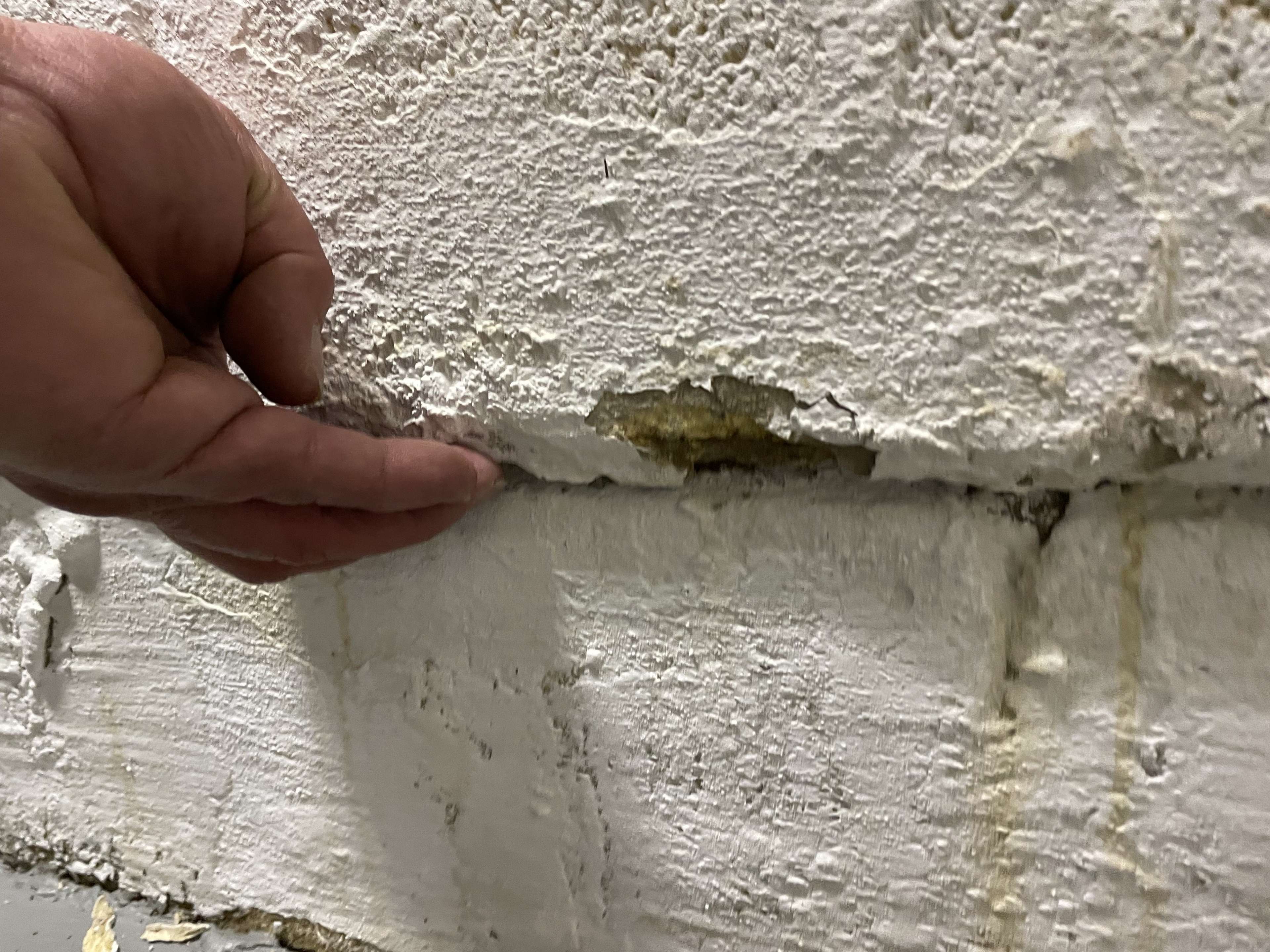 separation between sections of an interior wall due to wall shearing.