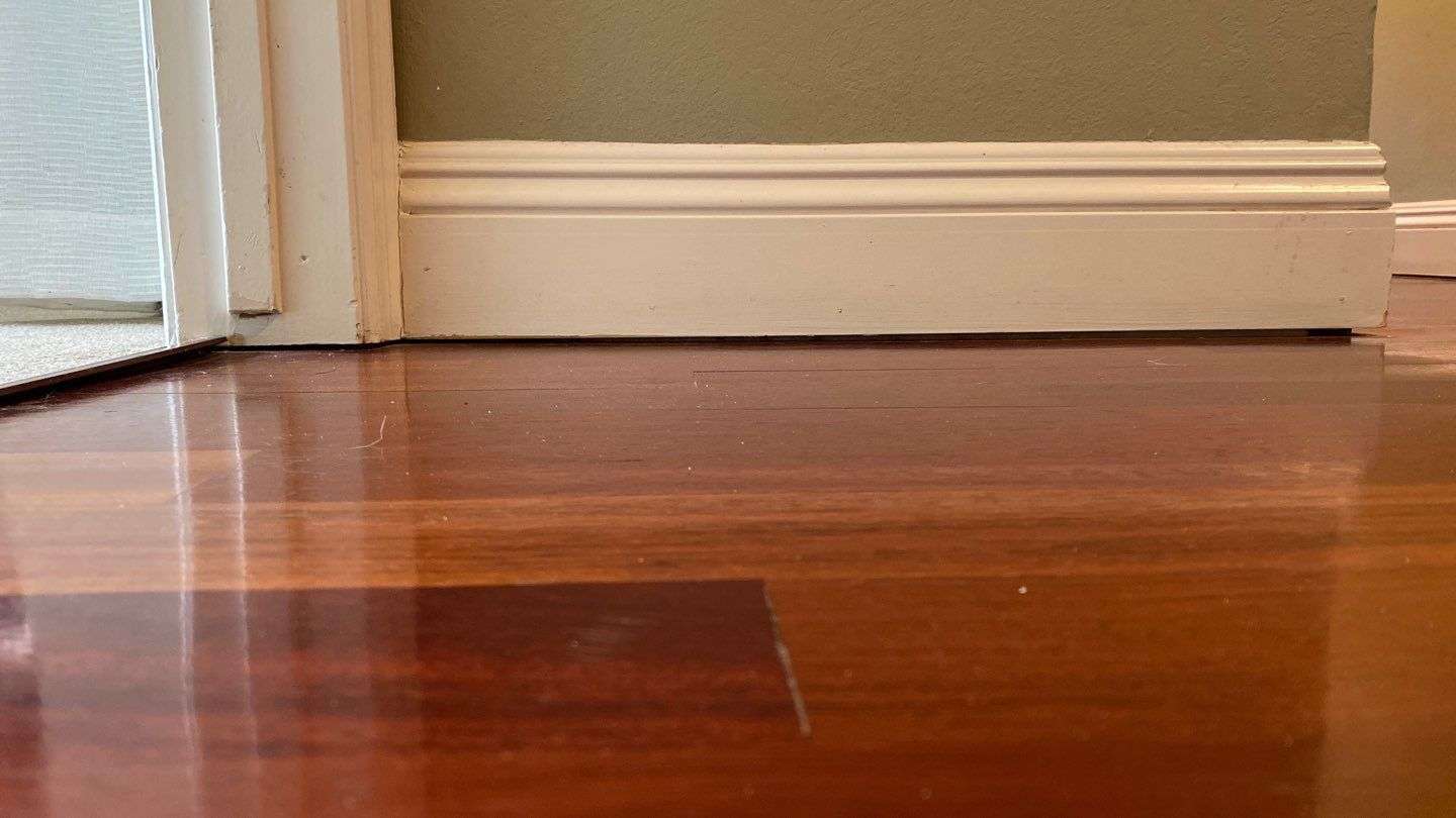 gap between the floor and wall, indicating uneven floors