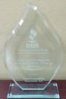 Glass award with "2016 Torch Award for Business Ethics, Winner, Category II" engraved on it.