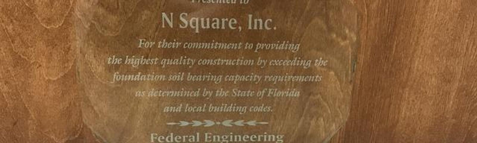 Clear glass award for N Square, Inc. from Federal Engineering & Testing, Inc., recognizing quality construction, 2017.