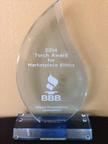 Glass award inscribed with "2014 Torch Award for Marketplace Ethics" from BBB, given to Alpha Foundation Specialists.