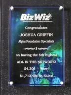 A plaque congratulating Joshua Griffin for high sales achievements with BizWiz and Alpha Foundation Specialists.