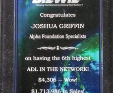 A plaque congratulating Joshua Griffin for high sales achievements with BizWiz and Alpha Foundation Specialists.