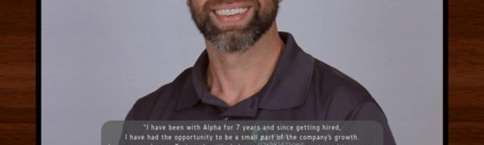 Smiling man with a beard in a framed photo, text about his work experience at Alpha below.