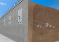 Diagram of a retaining wall with soil anchors on a sunny day.