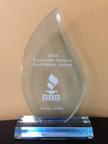 A crystal award with "2014 Customer Service Excellence Award" and "BBB" logo, engraved with "Joshua Griffin.