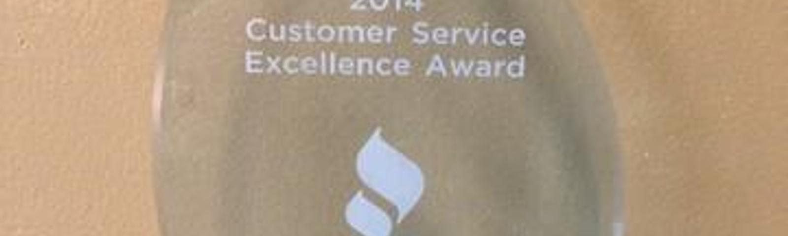 A crystal award with "2014 Customer Service Excellence Award" and "BBB" logo, engraved with "Joshua Griffin.
