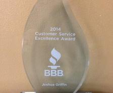 A crystal award with "2014 Customer Service Excellence Award" and "BBB" logo, engraved with "Joshua Griffin.