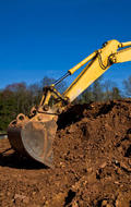 Bobcat digging up soil.