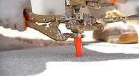 Alpha crew member injecting polyurethane into concrete slab.