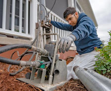 Alpha crew member installing pier at porch.