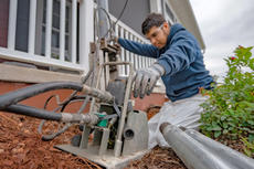 Alpha crew member installing pier at porch.