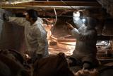 Alpha crew members inspecting crawl space