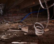 Debris and dirt in crawl space.