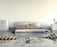 Bedroom with flooding water, a wet alarm clock, floating pillows, and half-submerged furniture.