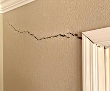 interior wall crack from door to corner