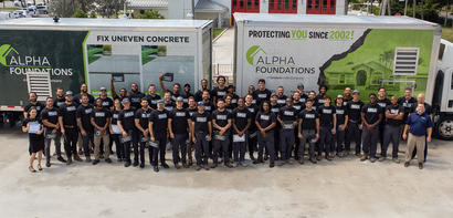 Alpha Foundations employees standing in front of box trucks