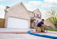 worker repairing a driveway with poly foam