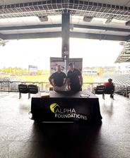 Alpha Foundations employees at a company booth during a Jacksonville Jumbo Shrimp game
