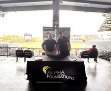 Alpha Foundations employees at a company booth during a Jacksonville Jumbo Shrimp game
