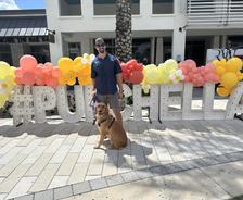Alpha Foundations employee standing with a dog at Pupchella 2026