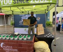 an Alpha Foundations employee stands at a company booth at the 75th Annual Monticello-Jefferson County Chamber of Commerce Watermelon Festival