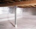 A metal support pole in a crawl space with foil insulation and a plastic-lined floor.