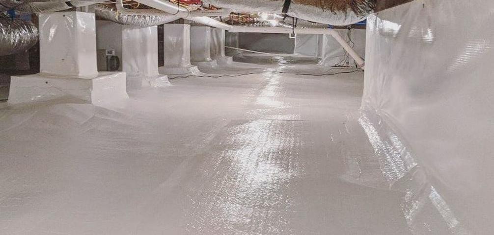 Clean, sealed crawl space with white plastic sheeting on the floor and walls, and visible ductwork above.
