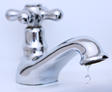 The faucet is dripping water, close up.