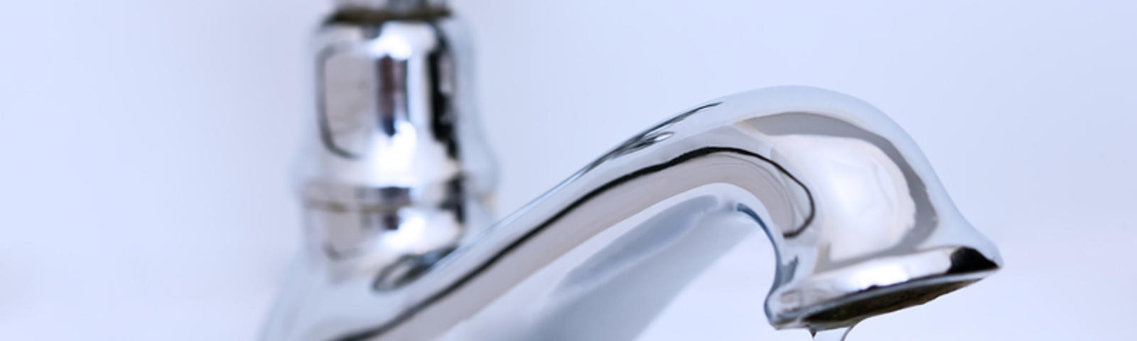 The faucet is dripping water, close up.
