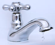 The faucet is dripping water, close up.