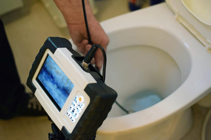 Snaking monitor testing clogged toilet