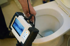Snaking monitor testing clogged toilet
