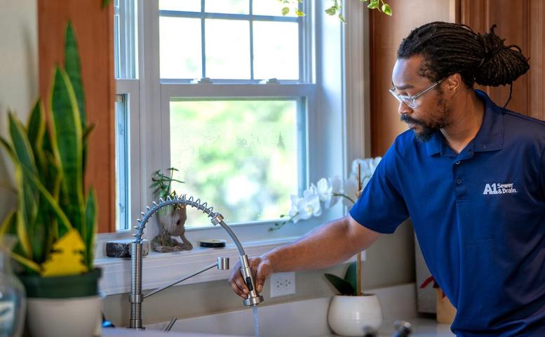 A1 technician checking water in kitchen sink.