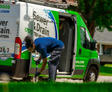 A1 technician checking water line and van outside of the home.