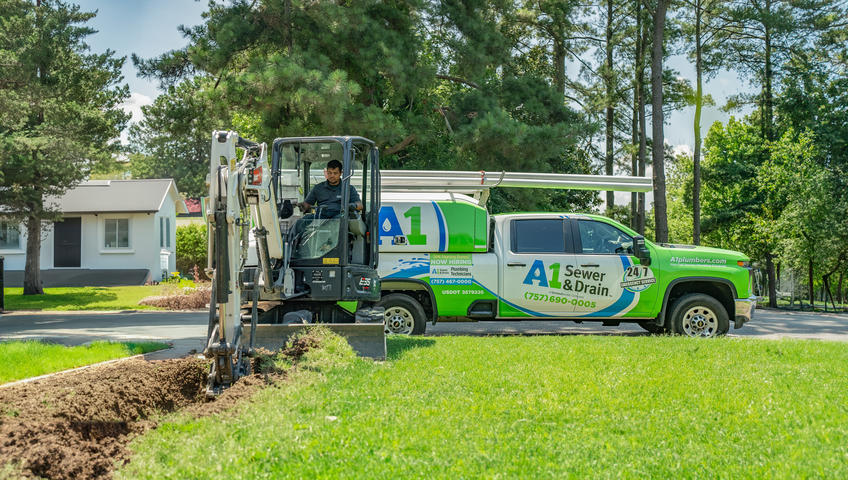 A1 Technician digging in front yard with A1 truck in the background.
