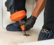 Technician snaking the drain of a bathtub.